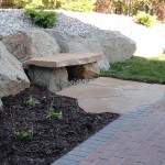 Rock bench integrated into hardscaping