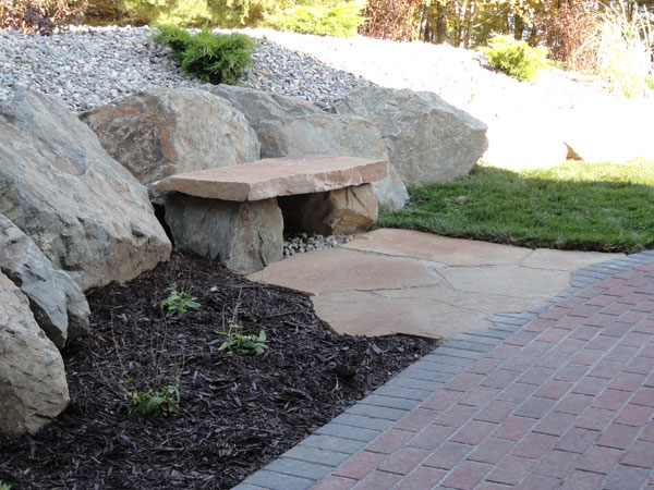 Rock bench integrated into hardscaping