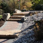 Stone and paver stairway leading to front of yard