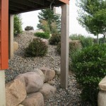 Large stones retaining the elevated change below the raised porch